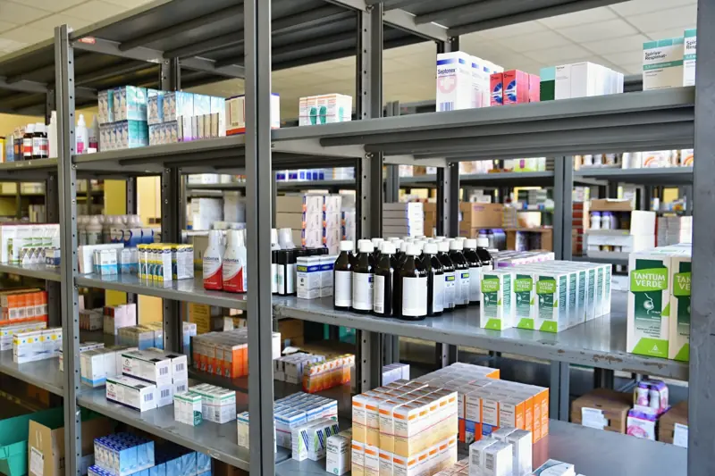 Pharmacy warehouse shelves stocked with medicines